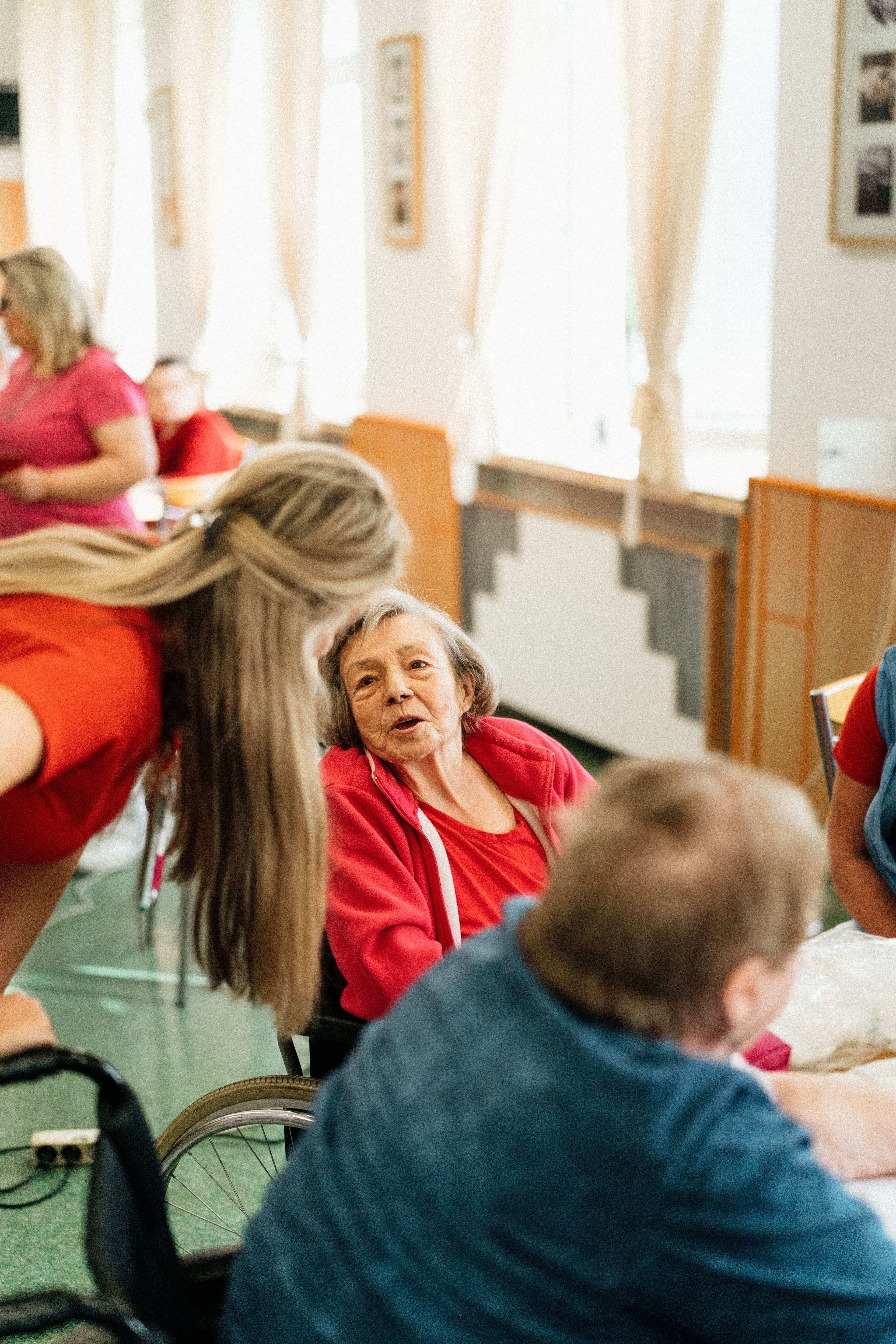 Caregiver checking in with a resident during a group activity