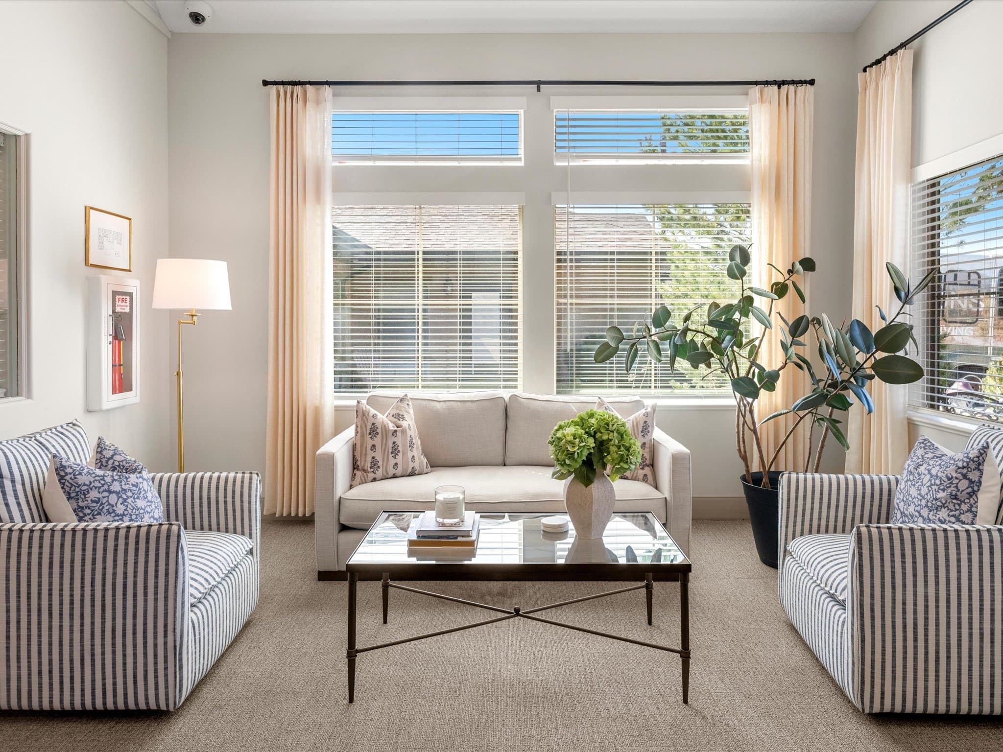 Sitting area with striped upholstered chairs near the entrance