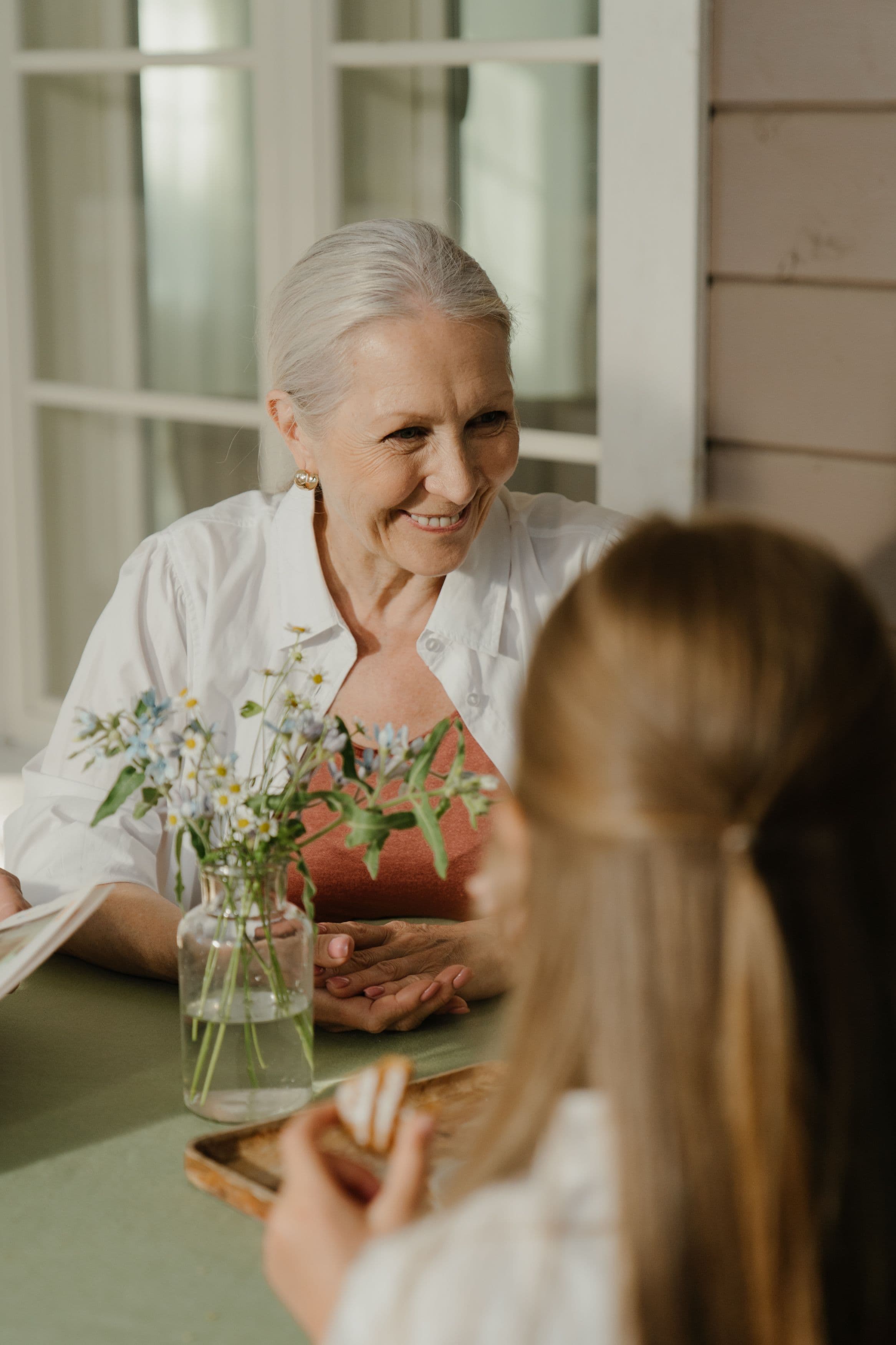 Resident enjoying a visit with a young family member outdoors